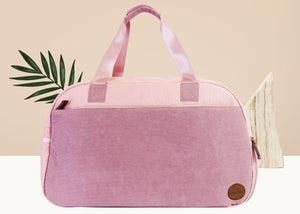 Pink Duffel Bag with leather patch in lower right corner. 